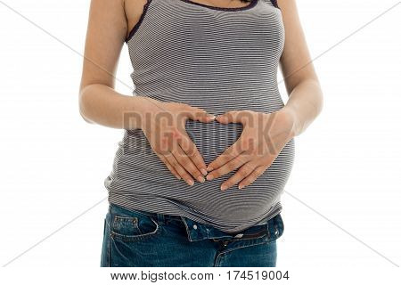 the midsection of a young pregnant woman close-up isolated on white background