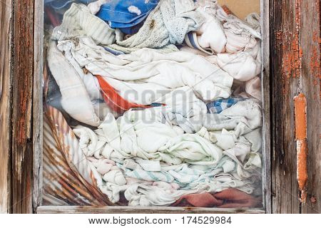 Old wrinkled clothes in the window of the house