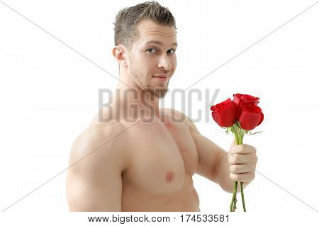 Handsome man holding a red rose and a bouquet of red roses. Sexy man gives a rose on a white background with a beautiful light. Isolated on white background