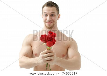 Handsome man holding a red rose and a bouquet of red roses. Sexy man gives a rose on a white background with a beautiful light. Isolated on white background. Selective focus