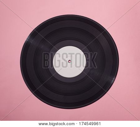black vinyl disс isolated on pink background with blank white area in center