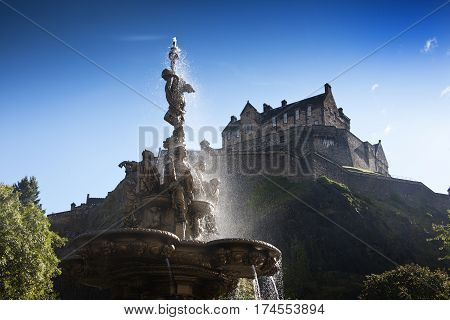 Edinburgh Castle with unlight through Ross Fountain