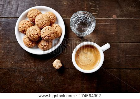 Cup of espresso, biscotti and a glass of water