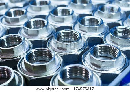 Plumbing connection fittings for plastic pipes. Orderly arranged in neat rows. Abstract industrial background.
