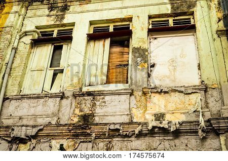 three weathered windows in asian backstreet, malaysia
