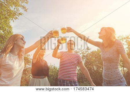 Several friends enjoying outdoors with the beer.