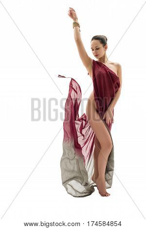 Pretty slim brunette wrapped in vinous cloth in graceful pose in studio