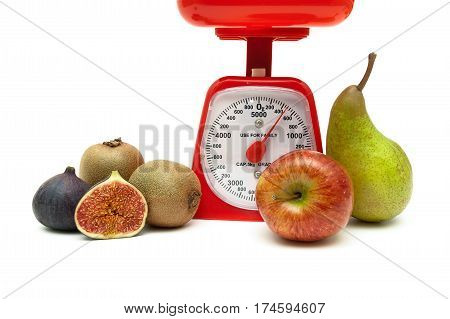 kitchen scales and fresh fruit on a white background. horizontal photo.