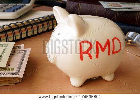 Piggy bank with word RMD. Retirement concept.