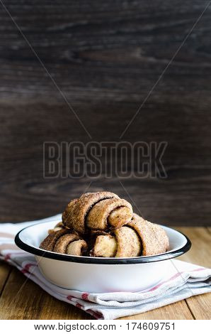 Croissants in a white plate on wooden table. Selective focus. Copy space