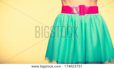 Woman fahion accessories clothing concept. Close up of pink belt on blue turquoise tulle skirt