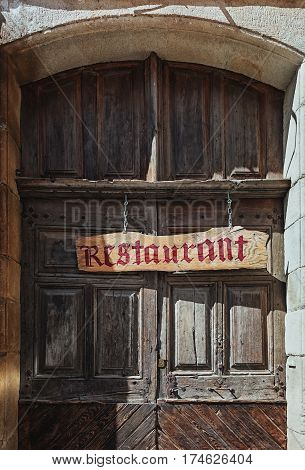 Largentiere France September 17 2015: Image of a restaurant door in a street in the center of Largentiere in the Ardeche region of France