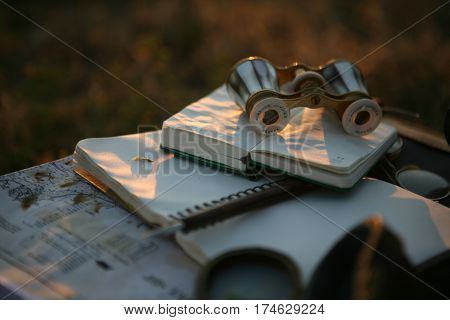 vintage pearl operaglasses and notepads in the sunset light