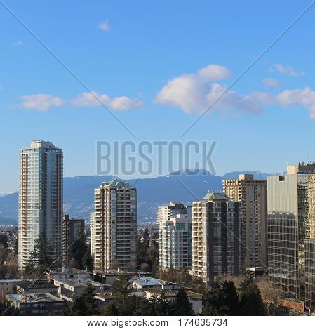 City Landscape With High Rises And Mountains
