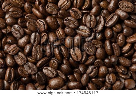 Abstract roasted coffee beans background. Macro photo