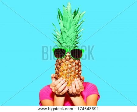 Fashion Portrait Woman And Pineapple With Sunglasses Over Colorful Blue Background