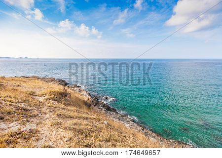 Beautiful seascape with rocks and meadow in cloudy blue sky at Khao Leam Ya National Park Rayong province Thailand