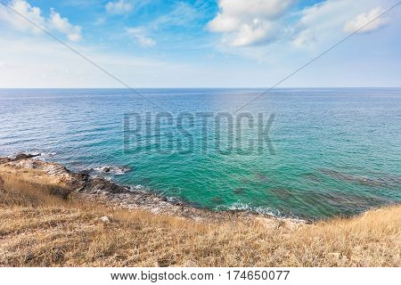 Beautiful seascape with rocks and meadow in cloudy blue sky at Khao Leam Ya National Park Rayong province Thailand