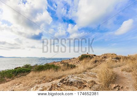 Beautiful seascape with rocks and meadow in cloudy blue sky at Khao Leam Ya National Park Rayong province Thailand