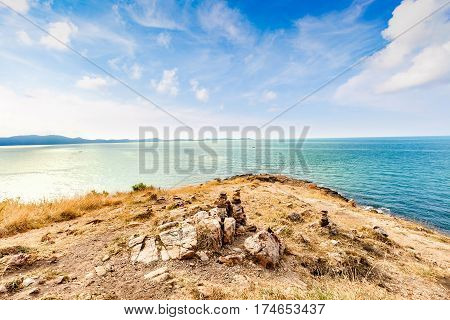Beautiful seascape with rocks and meadow in cloudy blue sky at Khao Leam Ya National Park Rayong province Thailand