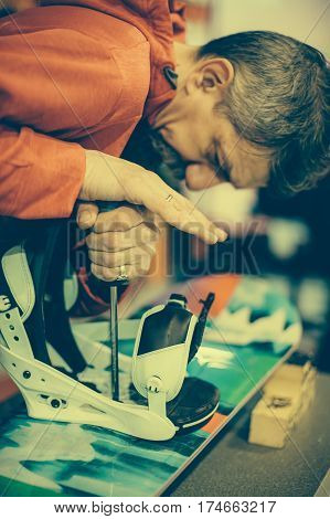 Snowboard Repair Shop Worker Adjust The Bindings