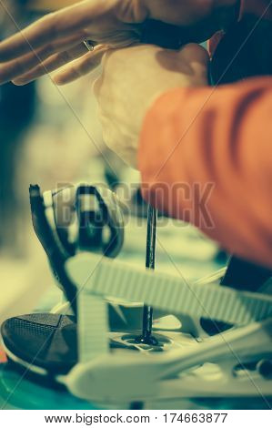 Snowboard Repair Shop Worker Adjust The Bindings