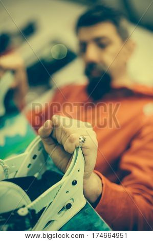 Snowboard Repair Shop Worker Adjust The Bindings