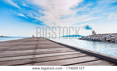 Wooden plank pier with seascape and bright blue sky for relax time at Khao Leam Ya National Park Rayong Province Thailand