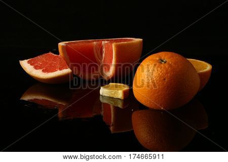still life on black background with citrus fruit