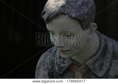 sculpture of a boy pioneer lowered his head with sad eyes