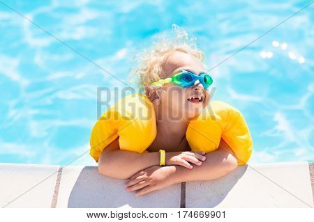 Little Baby Boy Playing In Swimming Pool