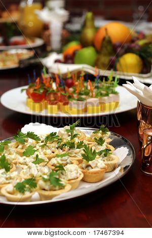 Banket stůl. Dortík umožňuje, saláty a ovoce košík s apple, pomeranče, hrozny a šťávu na poz