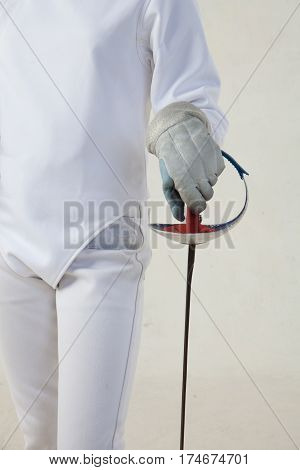 Female fencer hold the epee and wearing white fencing costume isolated on white background