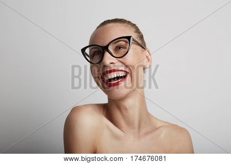 Portrait of beautiful smiling young woman. Wearing glasses
