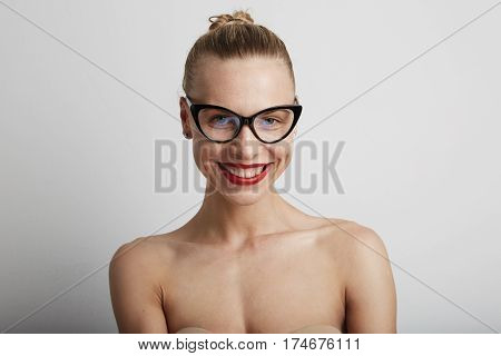 Portrait of beautiful smiling young woman. Wearing glasses