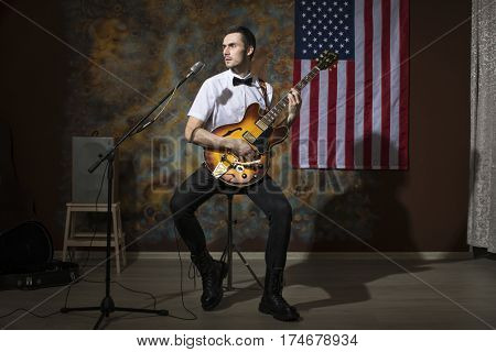 Moscow, Russia - Mart 03, 2017: Young rock musician with a vintage electric guitar Gibson es-345 1969 model year