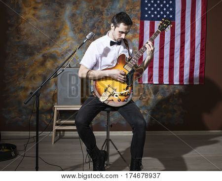 Moscow, Russia - Mart 03, 2017: Young rock musician with a vintage electric guitar Gibson es-345 1969 model year