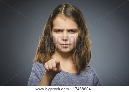 Closeup Thoughtful or contemptuous girl show at camera isolated on Gray.