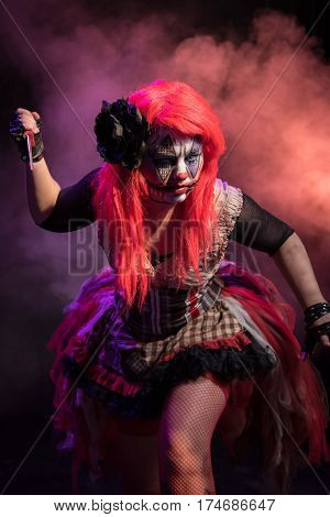 Theatrical lighting, special effects, and a custom makeup bring this evil clown to life. This is her circus now