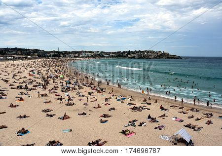 Sydney Australia - Feb 5 2017. People relaxing swimming and sun bathing on Bondi beach. Bondi beach is one of the most famous tourist sites in Australia.