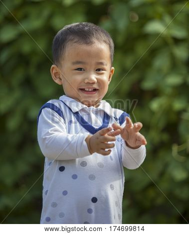 asian adorable children toothy smiling face happiness emotion outdoor portrait