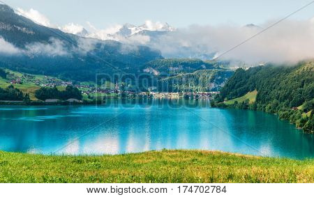 Amazing view of the Lungerersee lake in the morning mist. Lungern village, Switzerland, Europe.