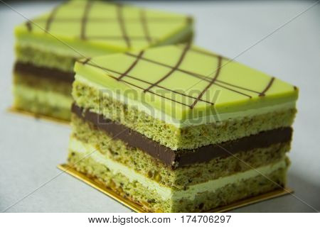 A pistacho layer cake and chocolate garnache