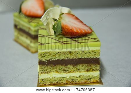 A pistacho layer cake and chocolate garnache