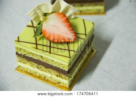A pistacho layer cake and chocolate garnache