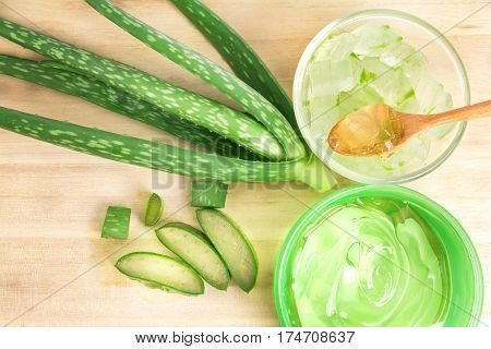 sliced and leaf of fresh aloe vera with aloe vera gel product on wooden plate natural clear gel as the star beauty ingredient for skin care