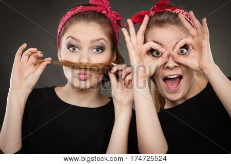 Craze fun and positive madness. Women showing their funny faces feel carefree. Girls in retro pin up fashion style present crazy behave.