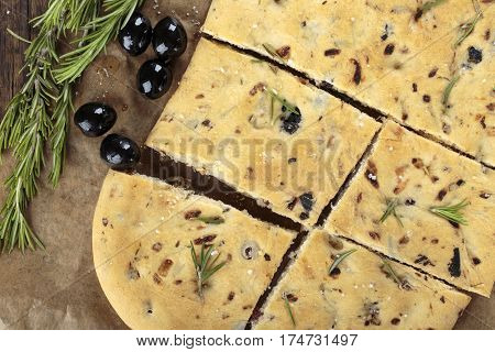Italian focaccia bread with olives and rosemary. Top view.