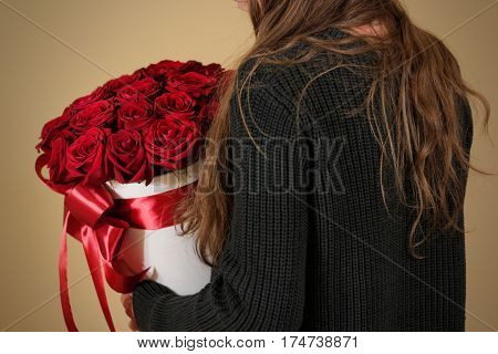 Girl In Black Jacket Holding In Hand Rich Gift Bouquet Of 21 Red Roses. Composition Of Flowers In A