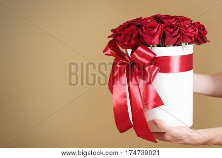 Man Hand Holding Rich Gift Bouquet Of 21 Red Roses. Composition Of Flowers In A White Hatbox. Tied W